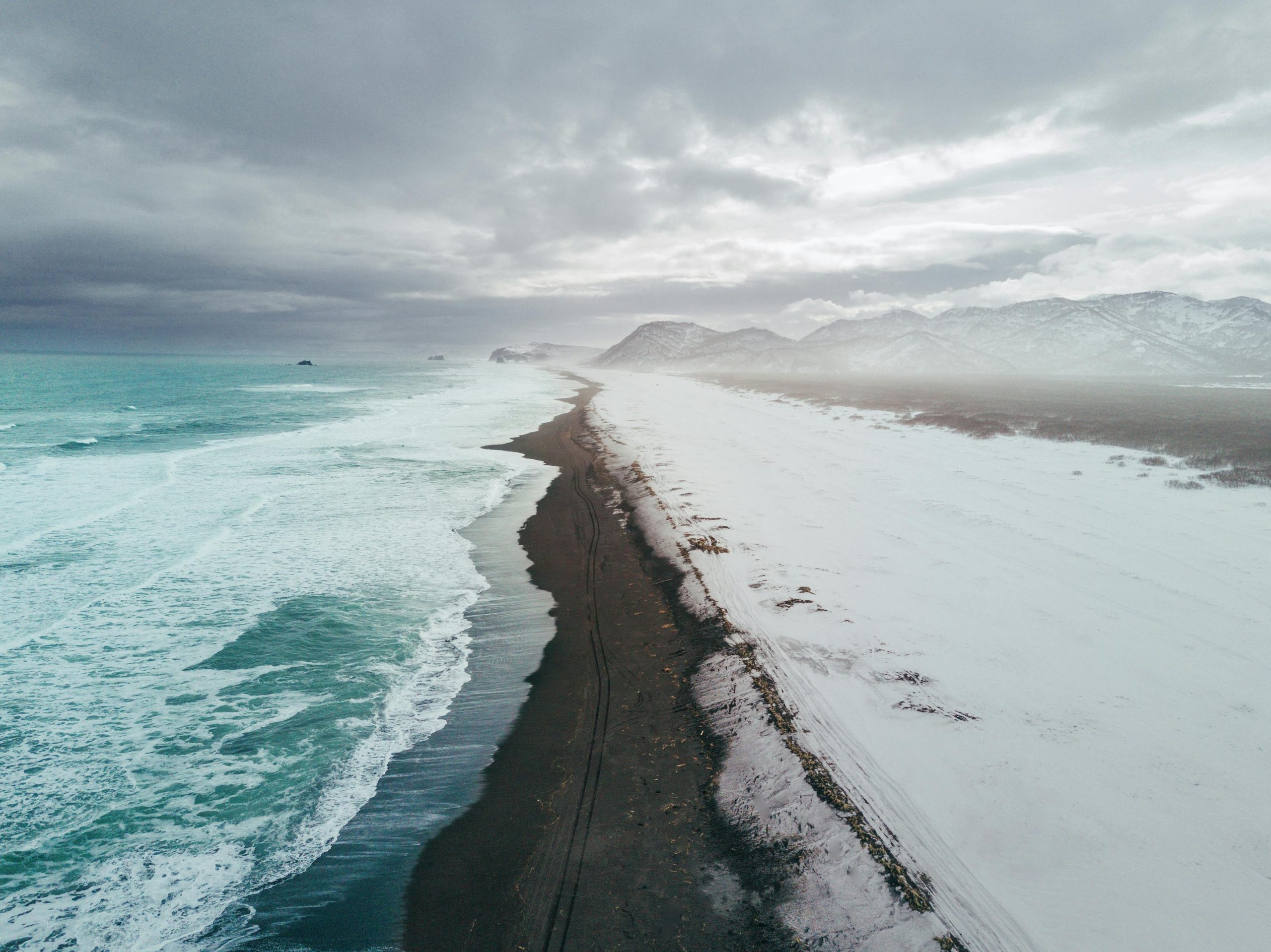 A breathtaking aerial view of a winter beach and mountains in Kamchatka, Russia.