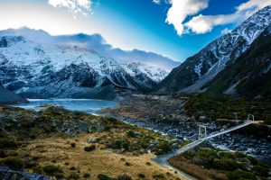 Breathtaking view of Aoraki Mount Cook with bridge and snow-capped peaks in winter.